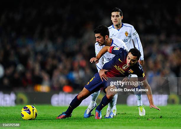 Xavi Hernandez of FC Barcelona duels for the ball with Alvaro Gonzalez of Real Zaragoza during the La Liga match between FC Barcelona and Real...
