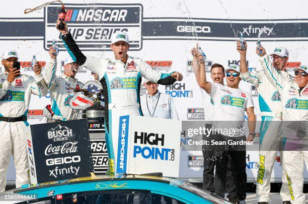 Denny Hamlin, driver of the Mavis Tires & Brakes Toyota, celebrates in victory lane after winning the NASCAR Cup Series HighPoint.com 400 at Pocono...