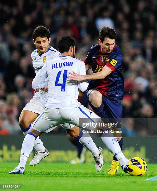 Lionel Messi of FC Barcelona duels for the ball with Alvaro Gonzalez of Real Zaragoza during the La Liga match between FC Barcelona and Real Zaragoza...