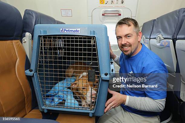 SeaWorld Rescue team member Jay Tacey assists a rescue dog onboard the Southwest Airlines flight. Sixty orphaned dogs and cats are being flown across...