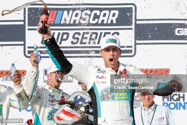 Denny Hamlin, driver of the Mavis Tires & Brakes Toyota, celebrates in victory lane after winning the NASCAR Cup Series HighPoint.com 400 at Pocono...