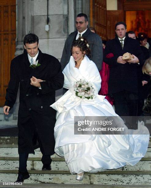 Canadian singer Roch Voisine and his bride Myriam St-Jean exit St. Viateur Church after their wedding, 21 December 2002, in Montreal. The couple met...