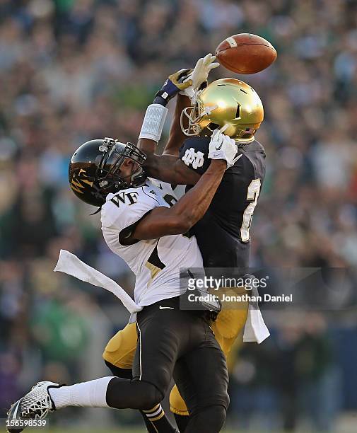 Chibuikem Okoro of the Wake Forest Demon Deacons breaks up a pass intended for Chris Brown of the Notre Dame Fighting Irish at Notre Dame Stadium on...