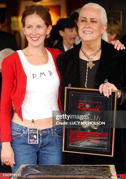 Singer Grace Slick poses with her daughter China Kantner after signing the cement in Hollywood's Rockwalk, in Los Angeles, 22 October 2002. Slick was...