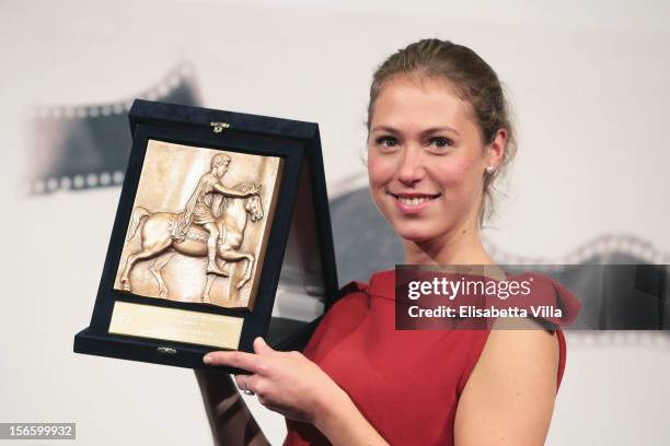 Actress Marilyne Fontaine poses with her Best Emerging Actress Award during the Award Winners Photocall during the 7th Rome Film Festival at...