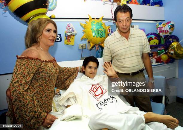 Ricky of Mexican band Magneto, recieves a visit from his parents 05 September 2002, at a hospital in Guatemala City were he is recovering after 3 of...