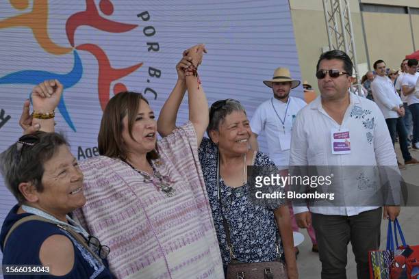 Senator Xochitl Galvez, an opposition presidential candidate, second left, takes a photograph with supporters during a campaign rally in Tijuana,...