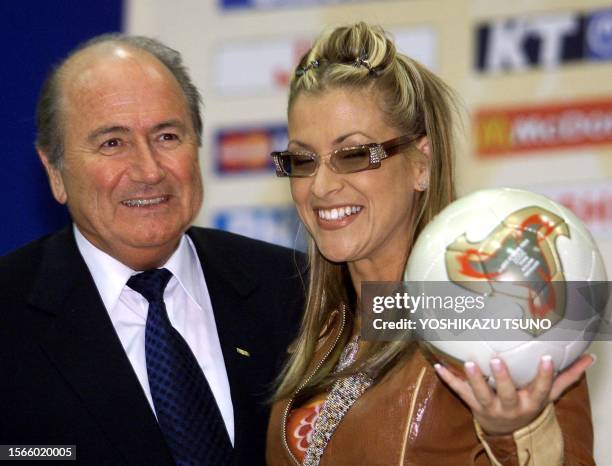 President Joseph 'Sepp' Blatter poses with US singer Anastacia as she holds up the official 2002 World Cup ball during a press conference at the...