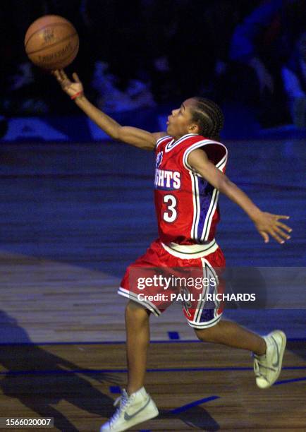 Young hip-hop star 'Lil Bow Wow runs down the NBA All Star Game court while crews shoot film footage for his new movie "Like Mike" during the Slam...