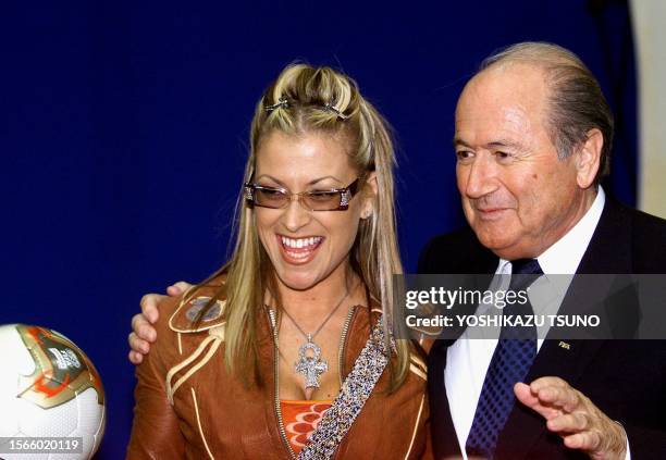President Joseph 'Sepp' Blatter poses with US singer Anastacia during a press conference at the media centre in Pusan, 30 November 2001, one day...
