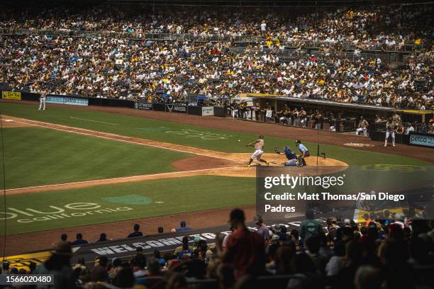 Gary Sanchez of the San Diego Padres hits a home run in the fifth inning against the Texas Rangers at Petco Park on July 30, 2023 in San Diego,...