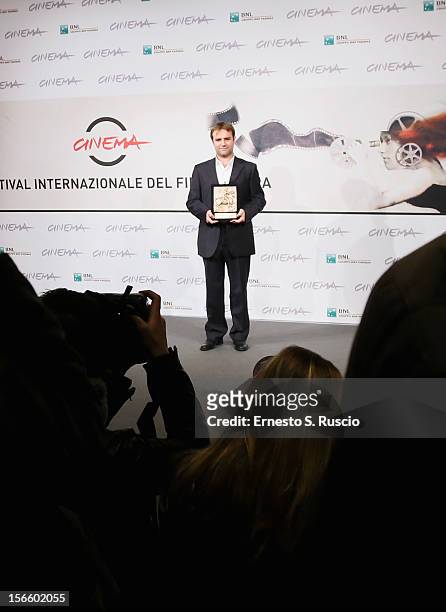 Director Francesco Amato poses with his Prospettive Award for Best Feature Film during the Award Winners Photocall during the 7th Rome Film Festival...