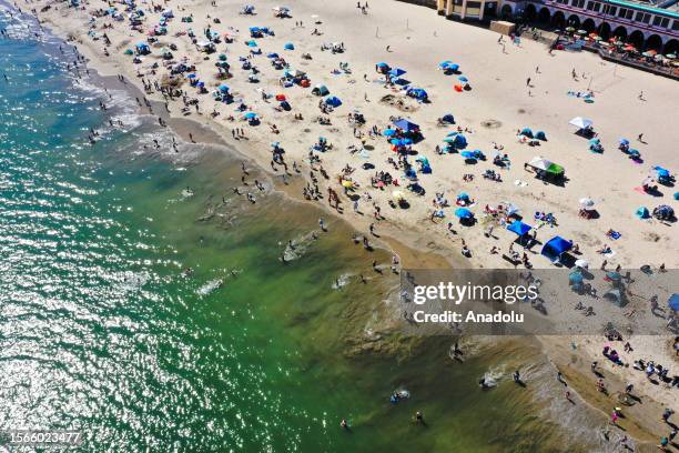 An aerial view of Santa Cruz Beach as crowd enjoy warm weather at the beach in Santa Cruz, California, USA on July 30, 2023.