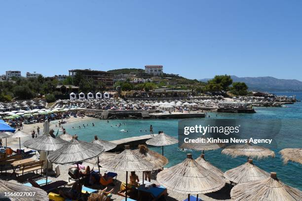 Tourists have fun at a beach in Sarande city, southern Albania, on July 30, 2023. In the first six months of 2023 396,932 foreign nationals visited...