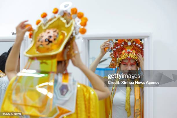 Ren Xin adjusts her headwear prior to an opening ceremony rehearsal in Chengdu of southwest China's Sichuan Province, on July 23, 2023. Ren Xin, a...