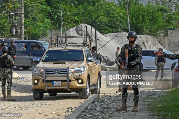 Security personnel stand guard at the site of a bomb blast in Bajaur district of Khyber-Pakhtunkhwa province on July 31, 2023. At least 44 people...