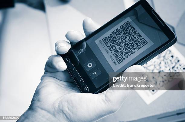 holding a smartphone photography qr code - promo code stock pictures, royalty-free photos & images