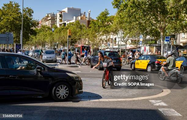 User of the rental bicycle from the city of Barcelona is seen in the Barceloneta neighborhood, near the beach, arguing with a car driver about who of...