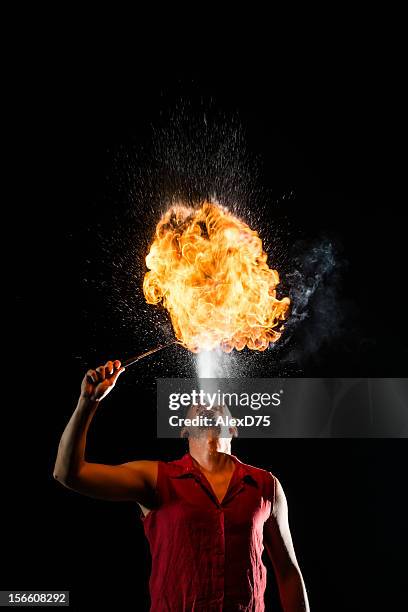street performer fire breather blowing on torch - circus stock pictures, royalty-free photos & images