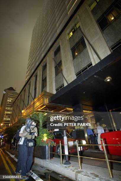 Cameraman films outside the Mandarin Hotel in Hong Kong where Hong Kong Cantopop singer and actor Leslie Cheung allegedly jumped to his death from...