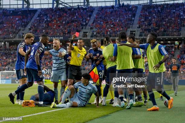 Alán Pulido of Sporting Kansas City is issued a red card during the first half of a Leagues Cup soccer match against FC Cincinnati at TQL Stadium on...