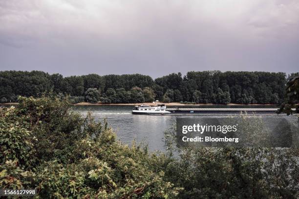 Bulk carrier barge sails along the Rhine River in Nierstein, Germany, on Wednesday, July 19, 2023. With water regularly receding to levels that...