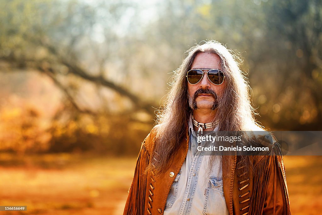 Man with long hair and sunglasses