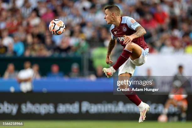 Lucas Digne of Aston Villa jumps for the ball in the second half during a Premier League Summer Series match between Aston Villa and Newcastle United...