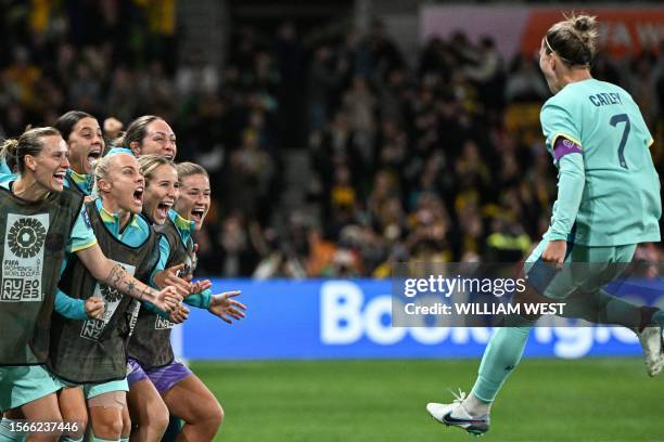 Australia's defender Stephanie Catley celebrates with teammates after scoring her team's fourth goal from the penalty kick during the Australia and...