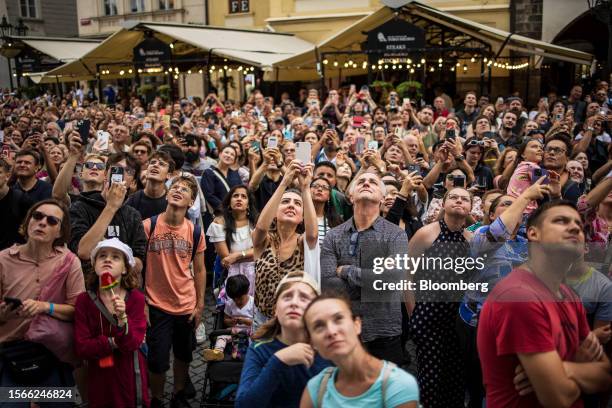 Tourists wait for the Prague astronomical clock hourly mechanized figurine show in the Old Market Square in Prague, Czech Republic, on Sunday, July...