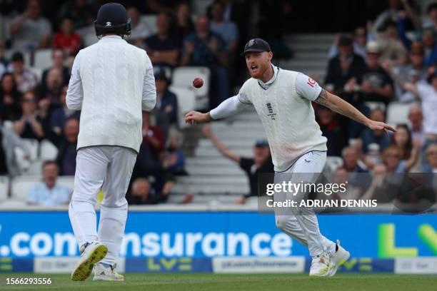 England's captain Ben Stokes reacts after taking a catch after the ball flicks the glove of Australia's Steven Smith off the bowling of England's...