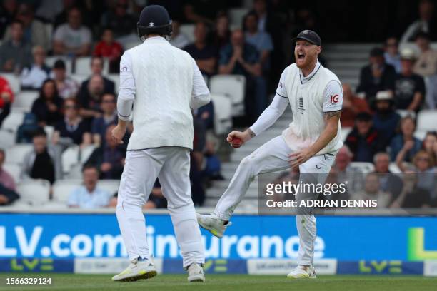 England's captain Ben Stokes reacts after taking a catch after the ball flicks the glove of Australia's Steven Smith off the bowling of England's...