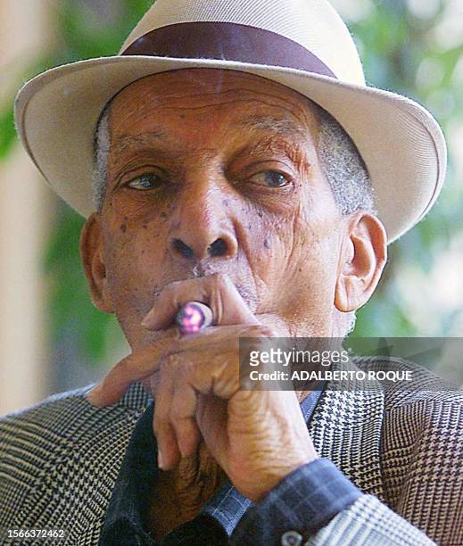 Cuban singer, Francisco Repilado world renown as "Compay Segundo", smokes a cigar on the morning of 08 February, 2000 in a bar in Havana, Cuba. El...