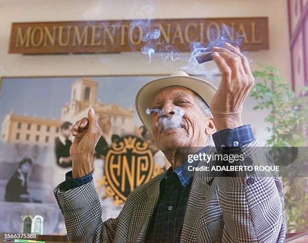 Cuban singer, Francisco Repilado, 92 years, known world wide as "Compay Segundo", savors a cigar the morning of 08 February, 2000 in a bar in Havana,...