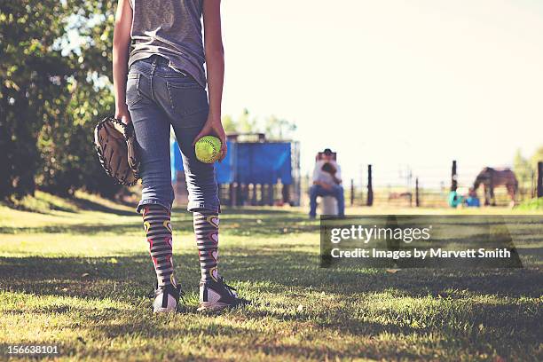 girl practicing fastpitch softball with catcher - softball stockfoto's en -beelden