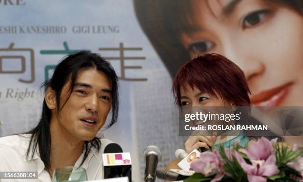 Taiwanese-born actor Takeshi Kaneshiro and Hong Kong Canto-pop singer Gigi Leung smile as they talk to reporters during a press conference in...