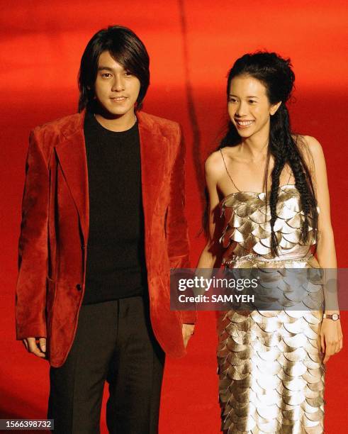 Taiwan pop singer Karen Mok and Taiwan's Chu Shuo-tien pose for a photo before the 14th Golden Melody Awards in Taipei 02 August, 2003. More then 50...