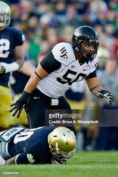 Nikita Whitlock of the Wake Forest Demon Deacons tackles Cierre Wood of the Notre Dame Fighting Irish in the first quarter of play at Notre Dame...