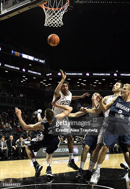 Cameron Biedscheid of the Notre Dame Fighting Irish drives to the basket as Ian Harward of the Brigham Young Cougars defends during the consolation...