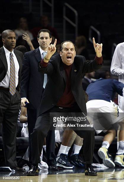 Head coach Mike Brey of the Notre Dame Fighting Irish signals to his team during the consolation game of the Coaches Vs. Cancer Classic against the...