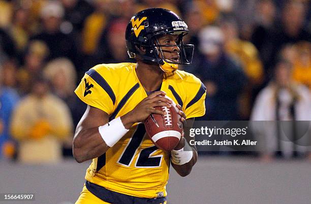 Geno Smith of the West Virginia Mountaineers drops back to pass against the Oklahoma Sooners during the game on November 17, 2012 at Mountaineer...