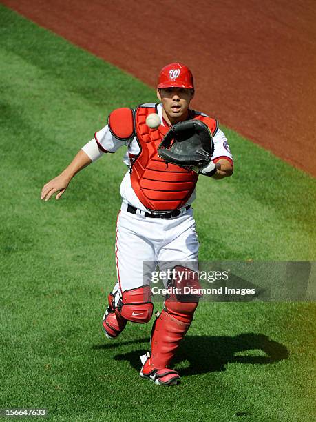 Catcher Kurt Suzuki of the Washington Nationals catches a ball in the outfield prior to Game Three of the National League Division Series on October...