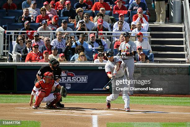 Outfielder Matt Holliday of the St. Louis Cardinals hits a pitch during the top of the first inning of Game Three of the National League Division...