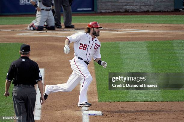 Outfielder Jayson Werth of the Washington Nationals rounds firstbase as he singles to lead off the bottom of the first inning of Game Three of the...