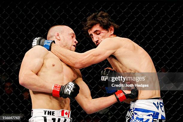 Mark Hominick connects on a punch to the body of Pablo Garza during their featherweight bout during UFC 154 on November 17, 2012 at the Bell Centre...