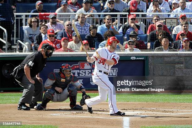 Outfielder Bryce Harper of the Washington Nationals flies out to rightfield during the bottom of the first inning of Game Three of the National...