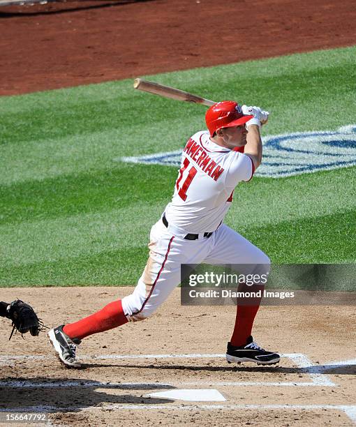 Thirdbaseman Ryan Zimmerman of the Washington Nationals singles to rightfield during the bottom of the third inning of Game Three of the National...