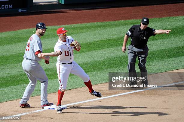 Thirdbaseman Ryan Zimmerman of the Washington Nationals makes an acrobatic throw to the secondbaseman as pitcher Chris Carpenter of the St. Louis...