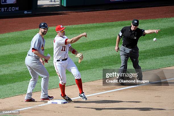 Thirdbaseman Ryan Zimmerman of the Washington Nationals makes an acrobatic throw to the secondbaseman as pitcher Chris Carpenter of the St. Louis...