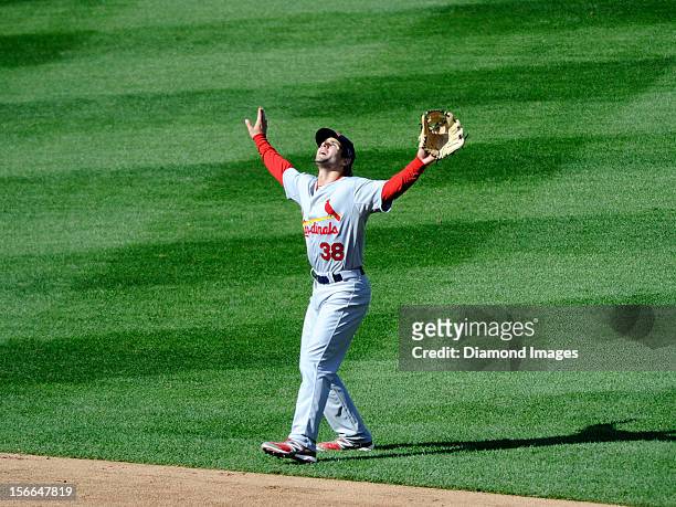Shortstop Pete Kozma of the St. Louis Cardinals calls for a pop flyball off the bat of outfielder Bryce Harper of the Washington Nationals during the...